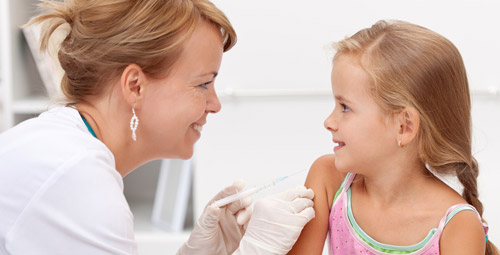 Doctor giving a young girl an injection